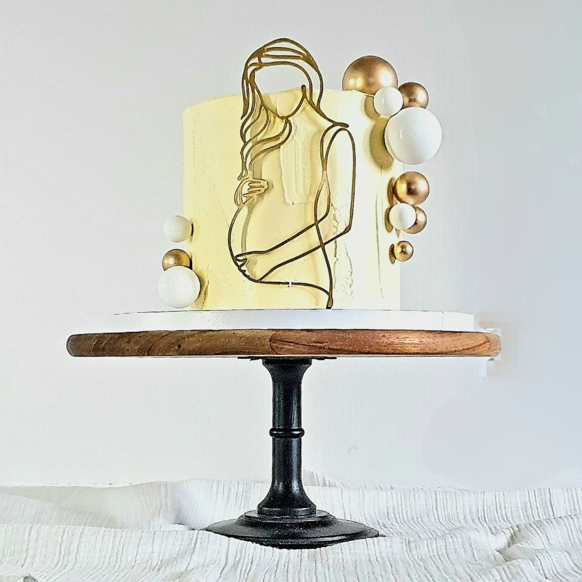 Image of a yellow cake showing a pregnant lady line art Plaque.