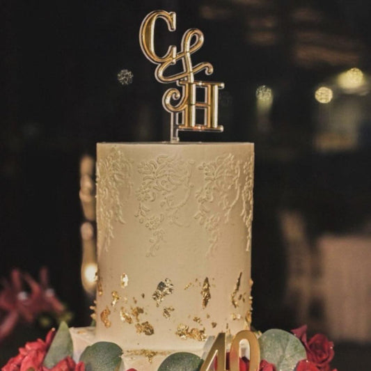 Decorative cake with gold lettering and number '40' on a blurred background